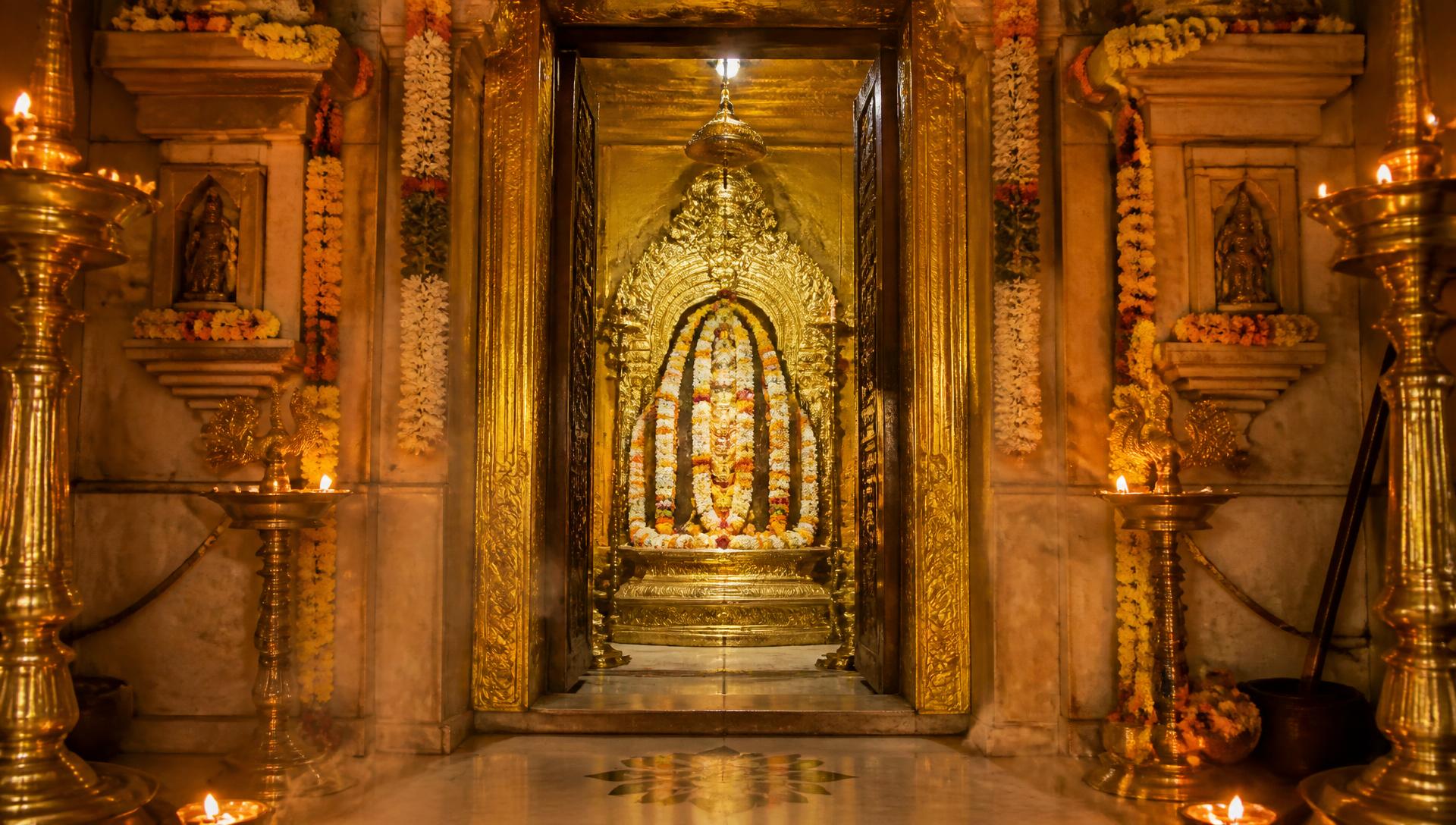 Golden temple sanctum illuminated by sacred lamps